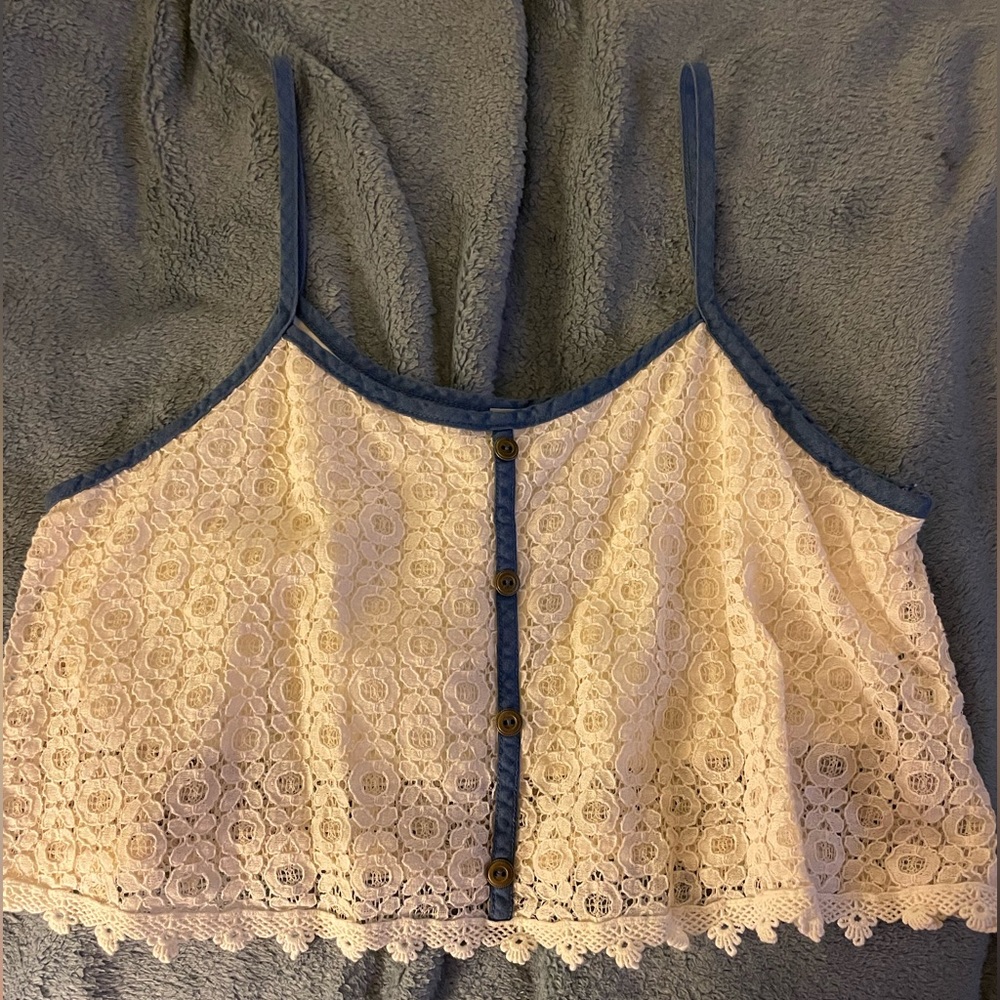 Cream crop top with lined bra area lined with blue piping
